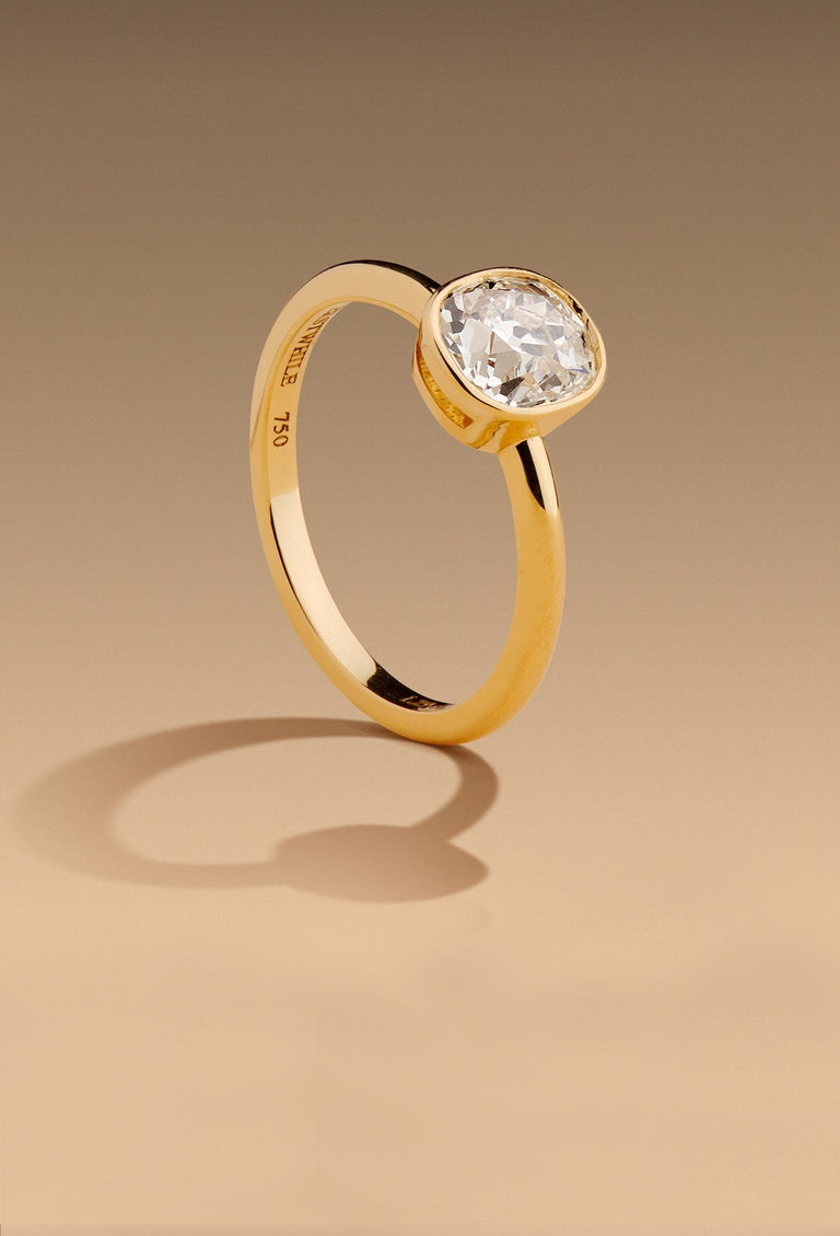 bezel setting solitaire gold engagement ring set with an antique old mine cushion diamond