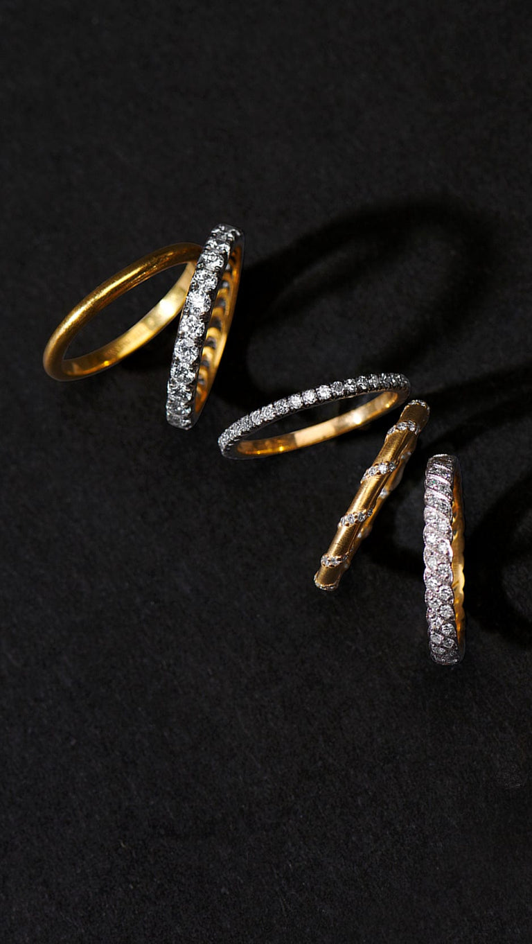 erstwhile wedding bands set with antique diamonds loose on a black background