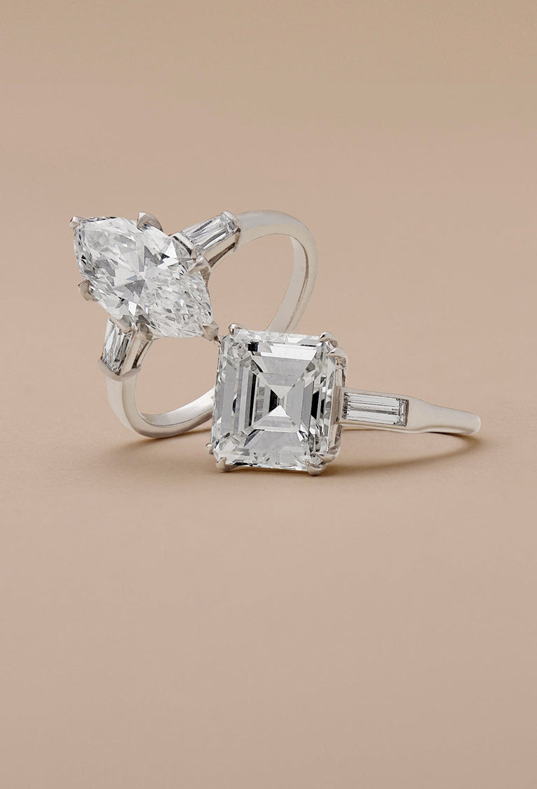 two midcentury engagement rings with a beige background